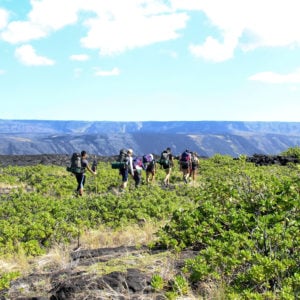 Embarking on a four-day backpacking trip with the 1969 to 1974 Mauna Ulu lava flows in the background. Mau loa o Mauna Ulu, 2019